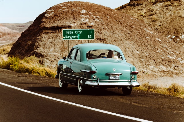 classic-green-car-travels-Arizona-during-Summers-outside-tuba-city