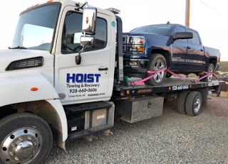 hoist towing flatbed towing pick up truck. Driving on unpaved roads