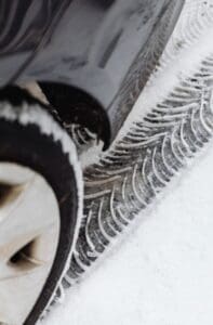 Vehicle driving through snow with winter tires