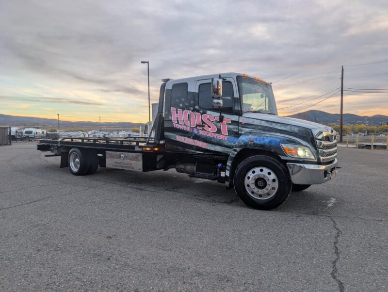 Hoist Towing and Recovery custom flatbed tow truck parked in Northern Arizona landscape