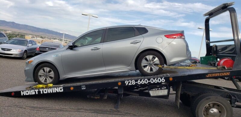 Hoist Towing unloading a vehicle from a flatbed tow truck in Prescott Arizona