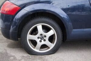 Passenger vehicle with a flat tire.